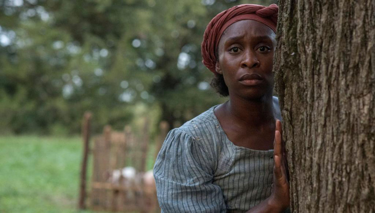 Harriet Tubman, from film, peering around tree