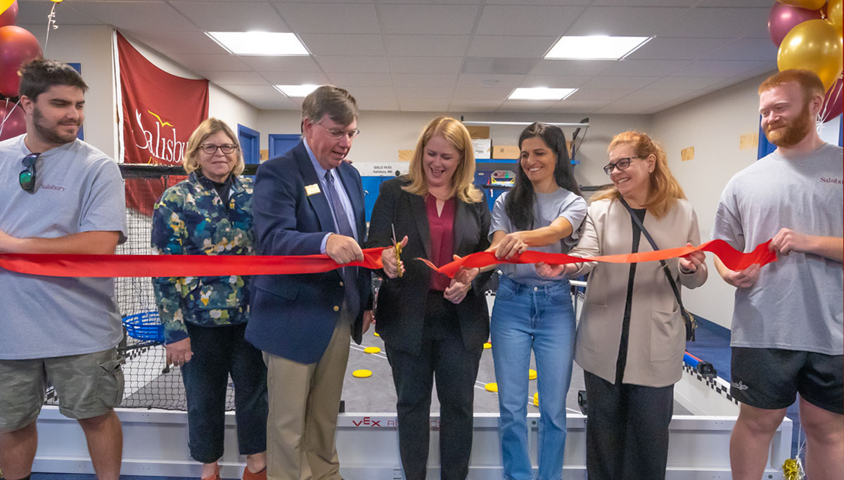 Students with SU leadership cutting ribbon to REAL Robotics Lab