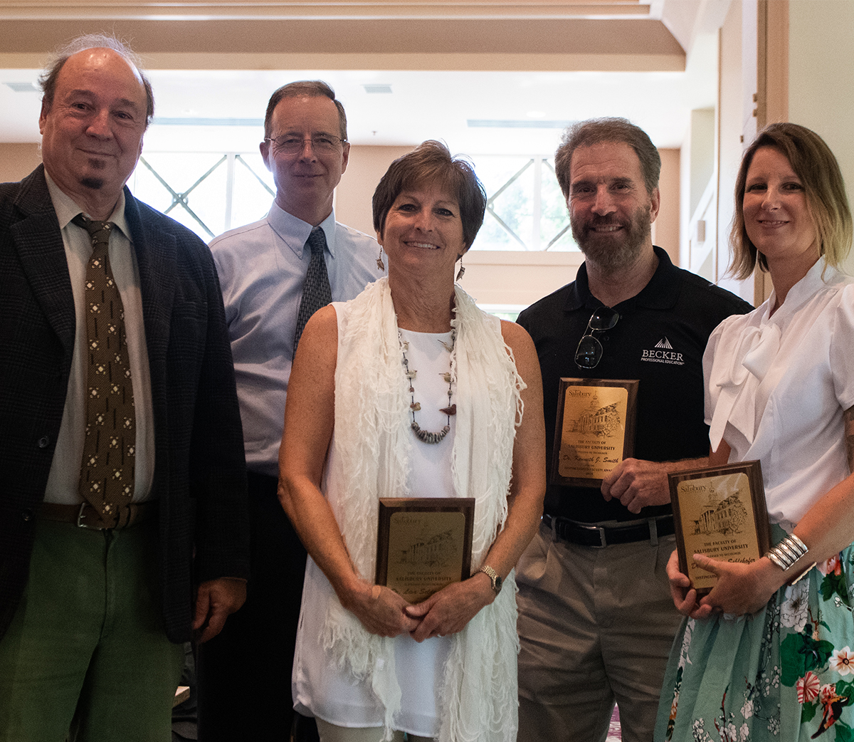 From left: Dr. James Forte, Distinguished Faculty Award Committee chair; SU President Charles Wight; and Drs. Lisa Seldomridge, Ken Smith and Michèle Schlehofer, recipients.