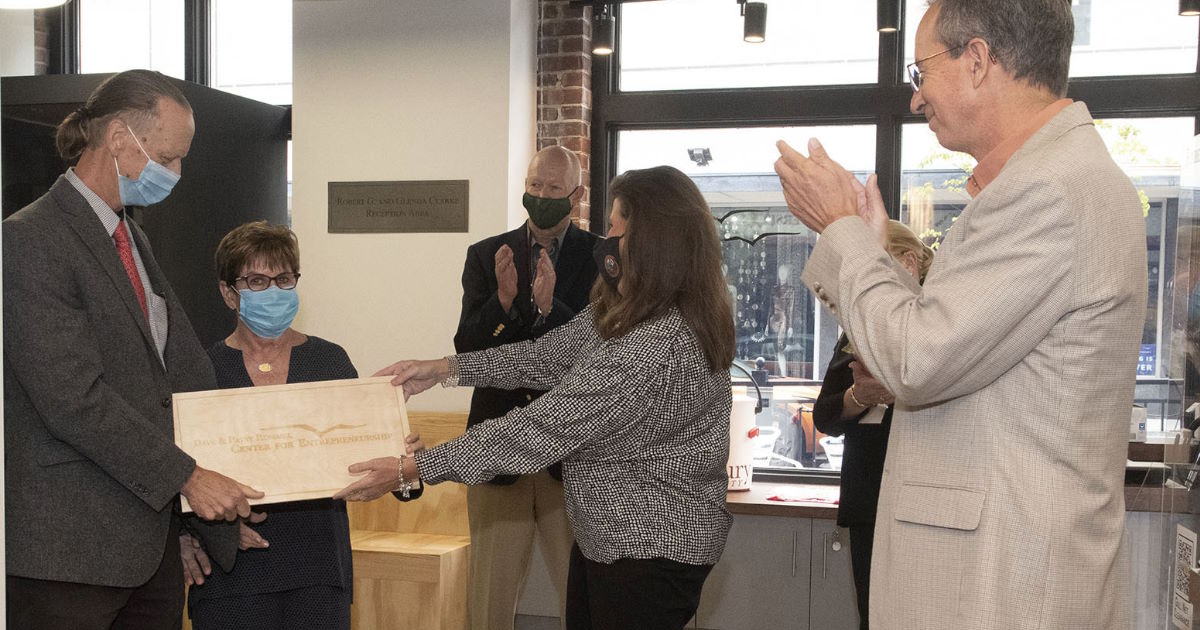 Philanthropists Dave and Patsy Rommel, left, accept a commemorative plaque from Perdue School Dean Christy Weer during the opening of the Dave and Patsy Rommel Center for Entrepreneurship.