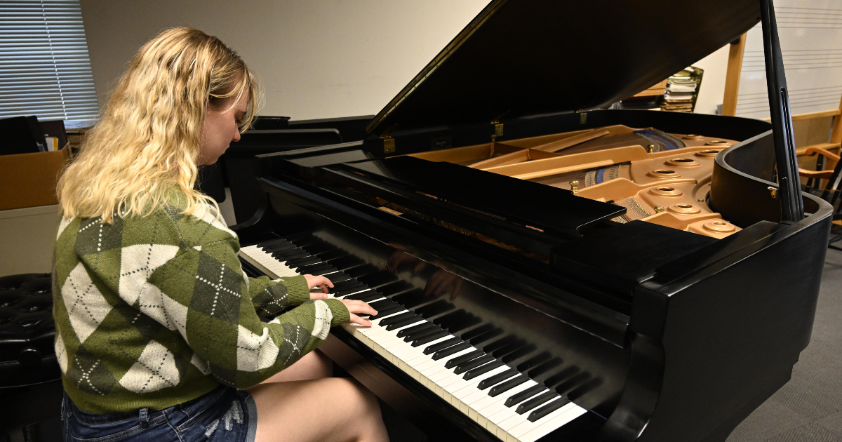 student playing grand piano